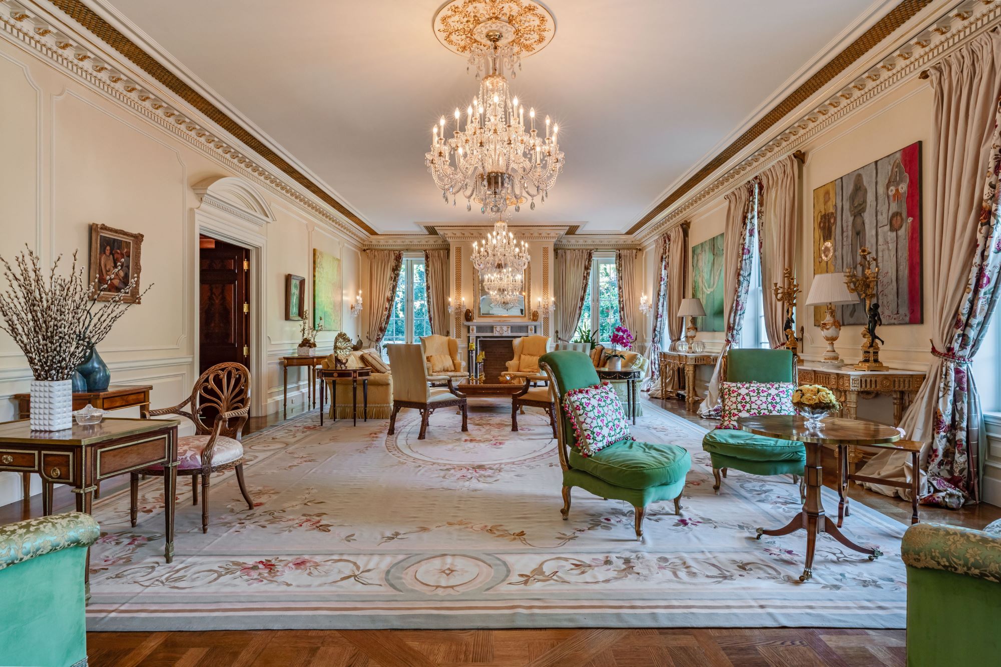 Luxurious living room in the Rosewood Estate, featuring chandeliers, elegant furniture, and ornate decor.