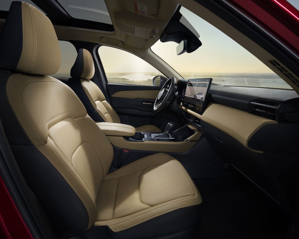 Interior of the 2026 Mazda CX-5 featuring beige leather seats, modern dashboard, and a panoramic view of La Jolla.