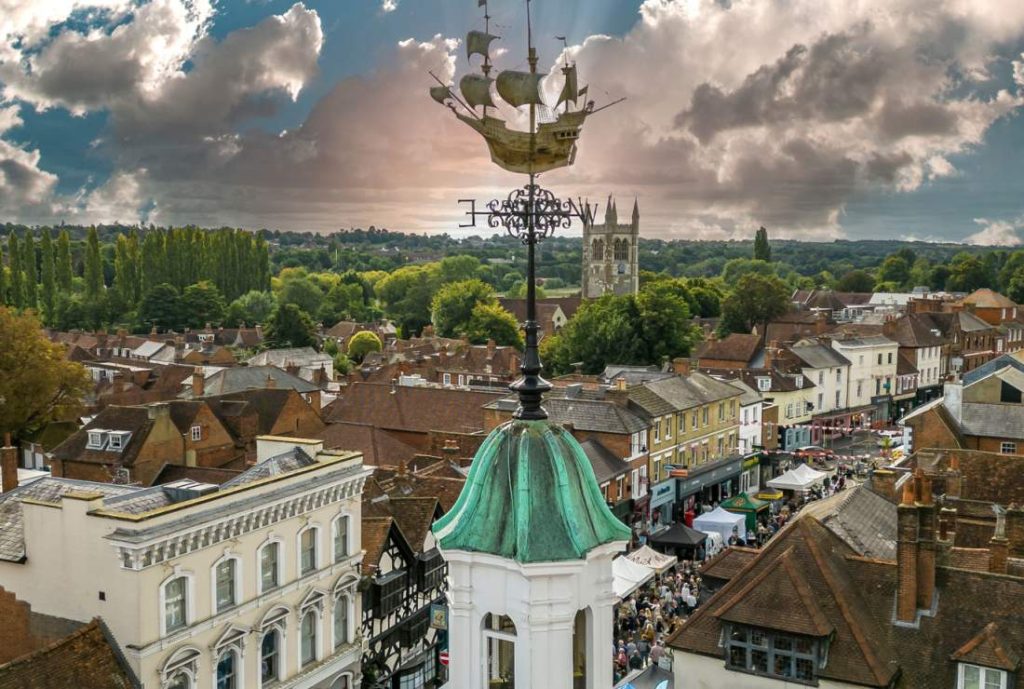 Aerial view of Farnham's historic town center featuring the iconic weathervane and St. Andrew's Church in the background.